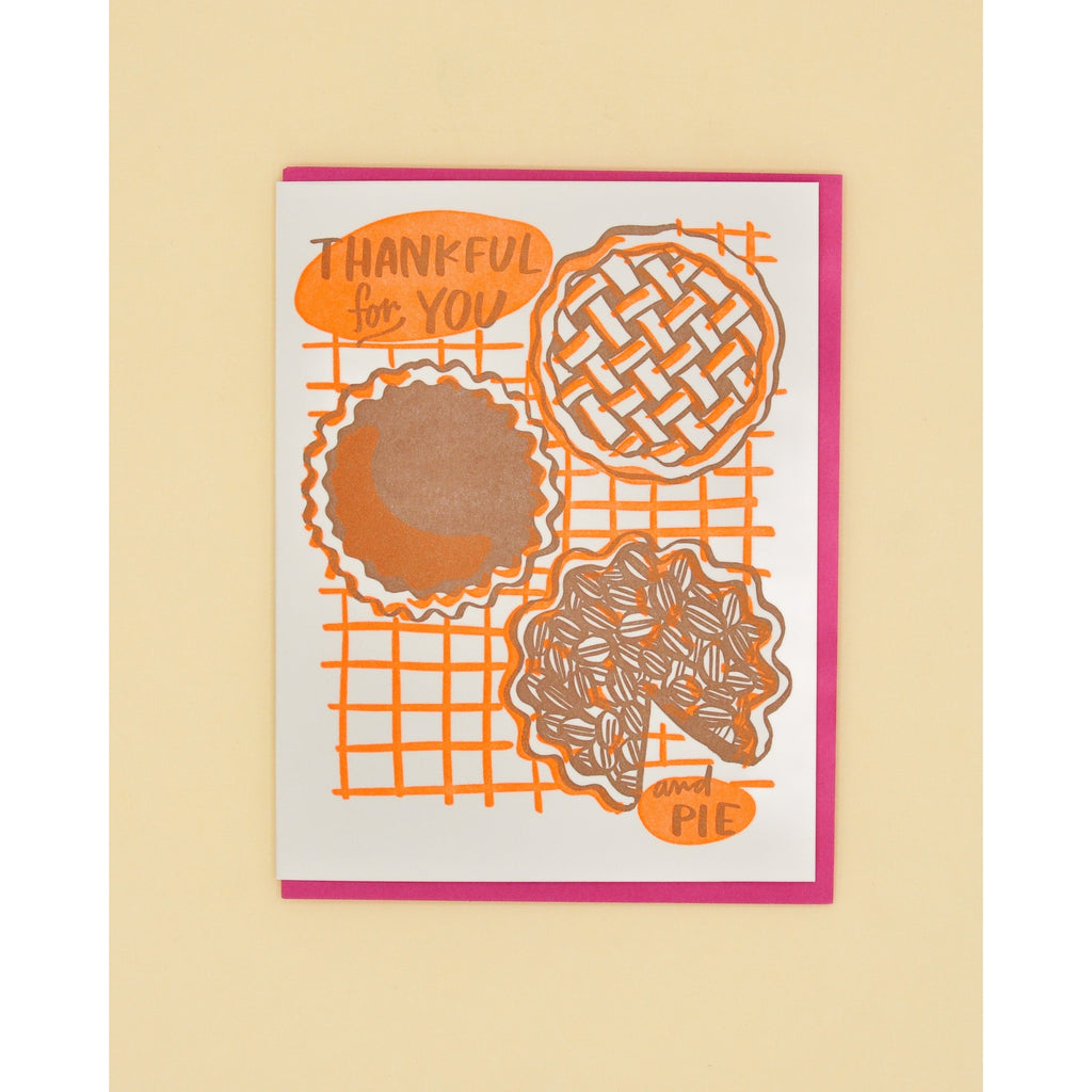 Ivory card with brown text saying, "Thankful For You And Pie". Images of brown and orange pies. A dark pink envelope is included.