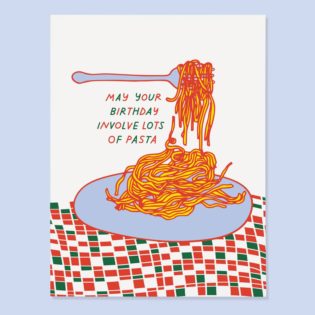 White background with image of a lavender plate of spaghetti in red and bright yellow with a purple fork with spaghetti twirled on it. The plate is on a tablecloth in pink, red, green and white. Green and red text says, “May your birthday involve lots of pasta”. An envelope is included.   