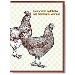 White card with blue dots and brown text saying, “Your breasts and thighs look fabulous for your age”. Images of two brown chickens. A brown envelope is included.