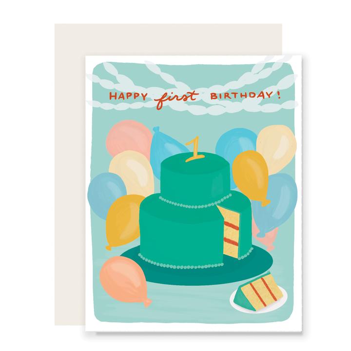 Teal card with orange text saying, “Happy First Birthday!” Image of a two tier green birthday cake with a yellow number 1 on top. Colored balloons in background. A white envelope is included.