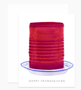 White card with gray text saying, "Happy Thanksgiving". Images of jellied cranberry sauce in a blue and white dish. A white envelope is included.