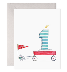 White card with image of a number one birthday candle sitting in a red wagon being pulled by a mouse holding a red flag saying, “Happy”. A purple envelope is included.