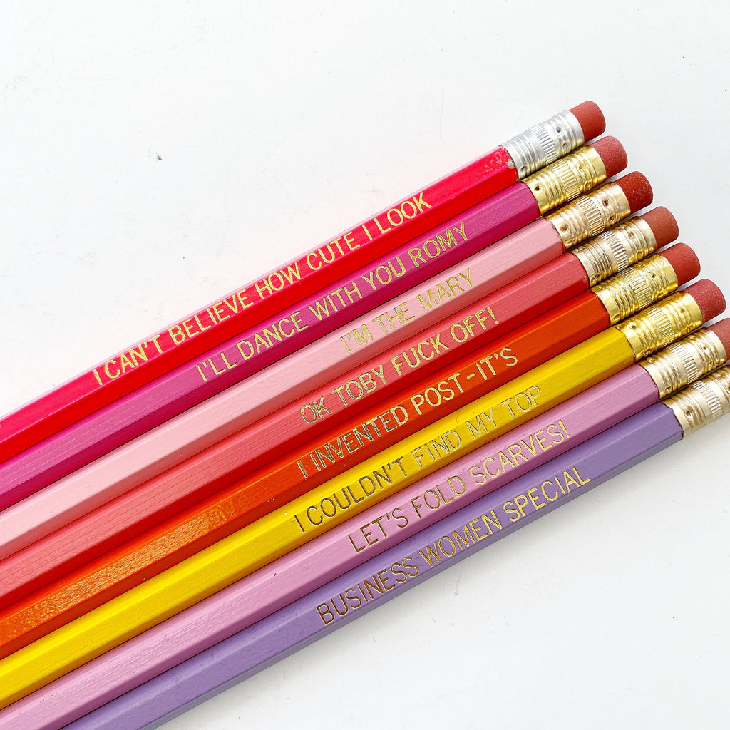 Set of pencils in pink, red, purple, yellow with gold foil text on each says, "I Can't Believe How Cute I Look I'll Dance With you Romy I'm The Mary OK Toby Fuck Off! I Invented Post-It's I Couldn't Find My Top Let's Fold Scarves! Business Women's Special". 