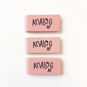 Image of three pink erasers with black text says, “Analog AF”.  