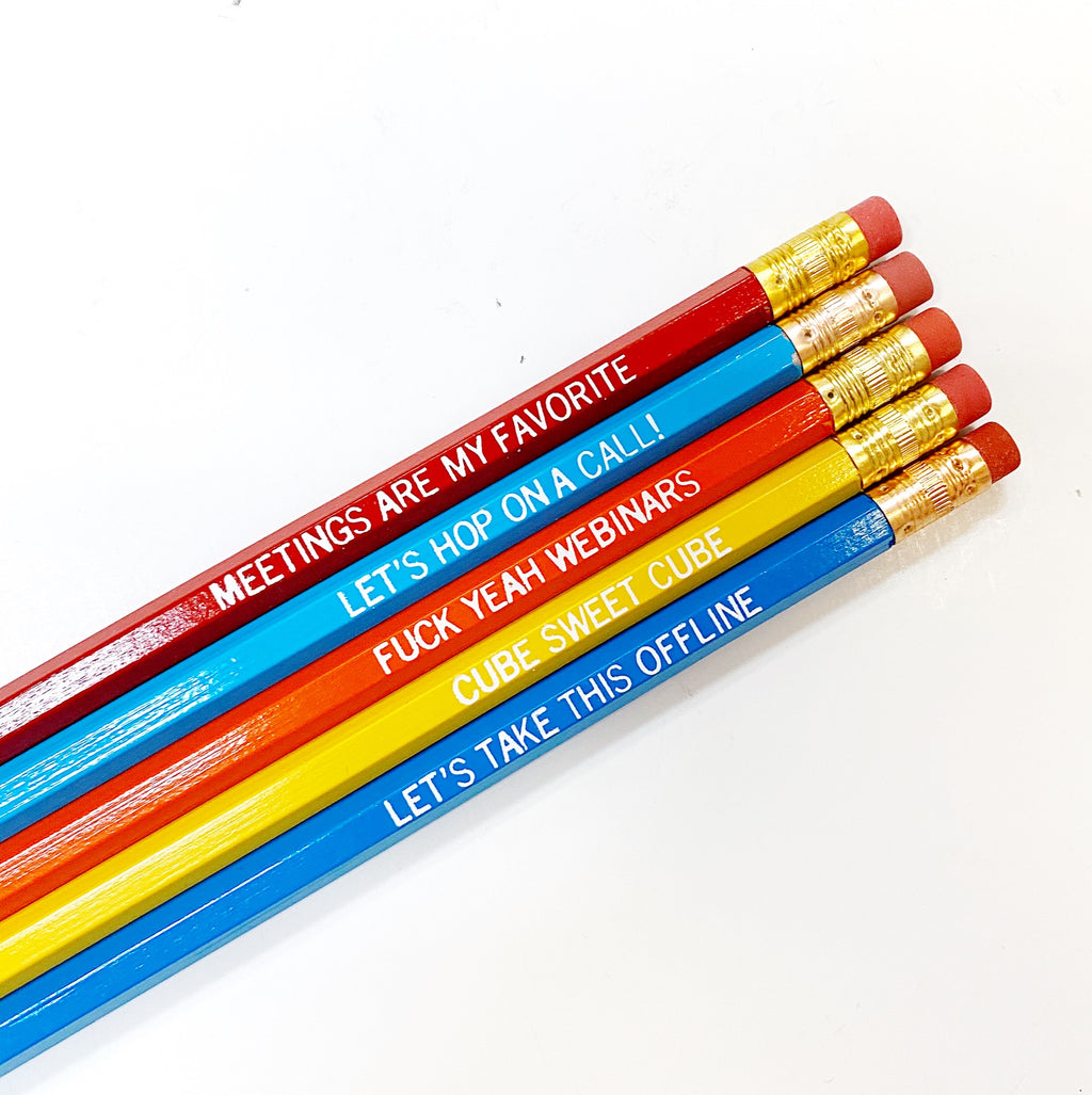 Image of five pencils with white text says, “Meetings are my favorite” on red pencil, “Let’s hop on a call!” on a light blue pencil, “Fuck yeah webinars” on an orange pencil, “Cube sweet cube” on a yellow pencil and “Let’s take this offline” on a blue pencil. All pencils have gold ferrule and pink erasers. 