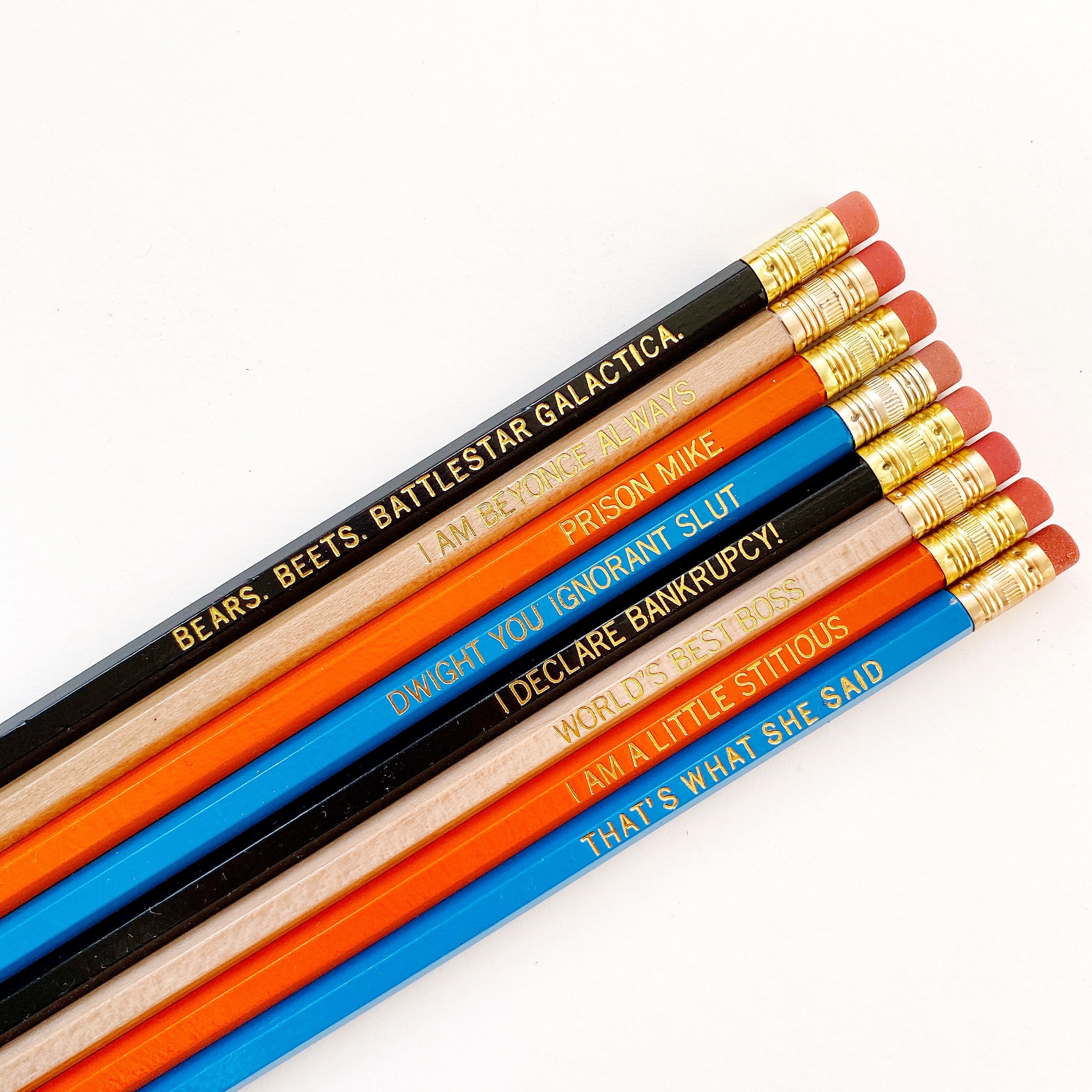 Image of pencil set in black, natural, orange and blue with gold text says, "Bears. Beets. Battlestar Galactica ","I am Beyonce Always ","Prison Mike ','Dwight You Ignorant Slut ','I Declare Bankruptcy! ","World's Best Boss ","I Am A Little Stitious ","That’s what she said"