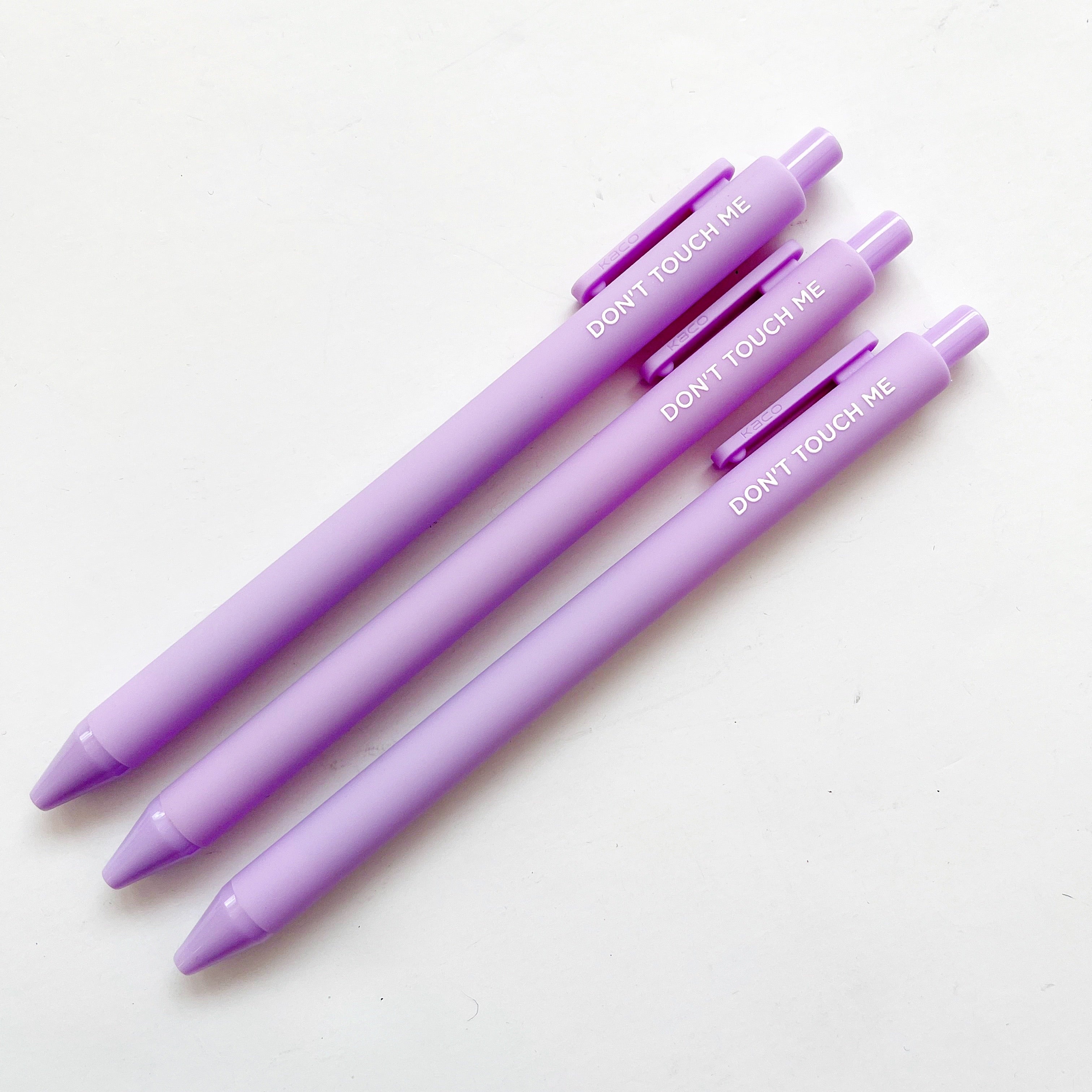 Lilac pens with white text says, "Don't touch me". 