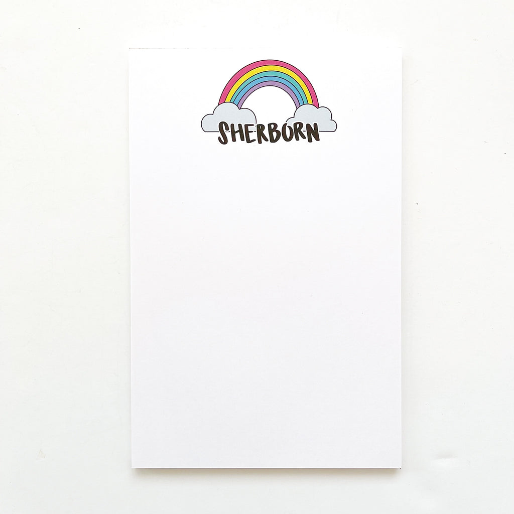 White background with image of rainbow with clouds and black text says, "Sherborn". 
