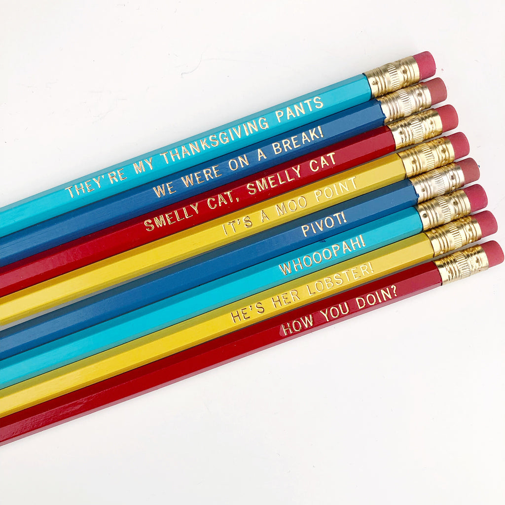 Pencils with gold foil text says, "Pivot!  We were on a break!  How you doin’?  Smelly cat, smelly cat Regina Phalange  Whooopah!  He’s her lobster!  It's A Moo Point ".