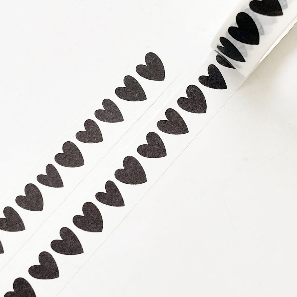 Image of Washi tape with white background with black hearts. 